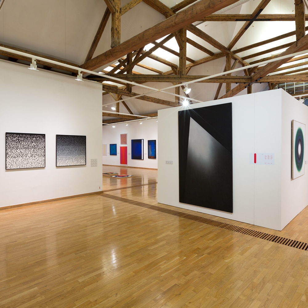 Przestrzeń centralna, od lewej trzy prace Ryszarda Winiarskiego z lat 1975-1976, wgłębi obrazy Andrzeja Gieragi (2010), Tamary Berdowskiej (2015), Marka Sobczyka (1980), Michała Misiaka (2010), Tadeusza Gustawa Wiktora (2011), Romualda Oramusa (2007-2010), pośrodku praca Józefa Robakowskiego (1975-1987), po prawej Wojciecha Fangora (1966), dalej kompozycja Kajetana Sosnowskiego (1967-1973).